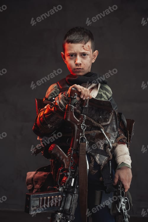 Preview: Armed with shotgun kid poses in dark background looking at camera