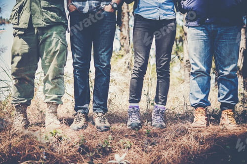 Preview: Close up of hikers team shoes while hiking to mountain together.