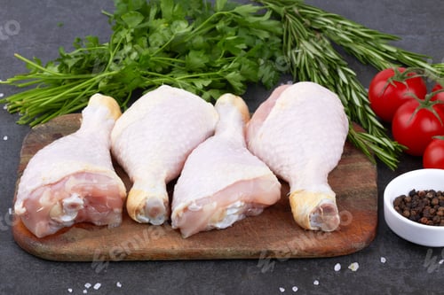 Preview: Raw Chicken Thighs and Herbs on Wooden Board