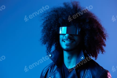 Preview: Portrait of fashion man with curly hair with stylish glasses on blue background multinational