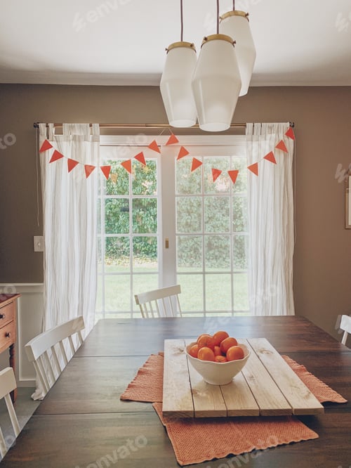 Preview: Dining room with an orange banner and oranges in a white bowl