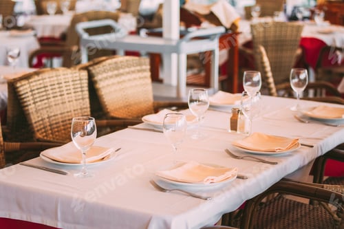Preview: Cozy Interior Of Summer Cafe - Sheltered Tables With White Tablecloths And Wicker Chairs. Nobody