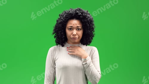 Preview: Young black female with a curly afro and a disappointed expression on a green screen background