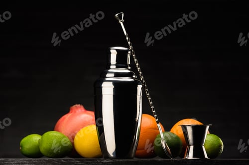 Preview: shaker for preparing alcohol cocktail and fruits on table isolated on black