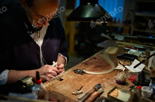 Preview: Violin maker repairing a bow