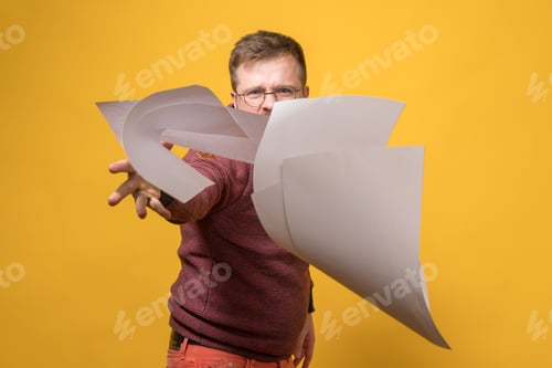 Preview: Man in stress and anger throws stack of white paper forward. Bad working day. Psychological concept.