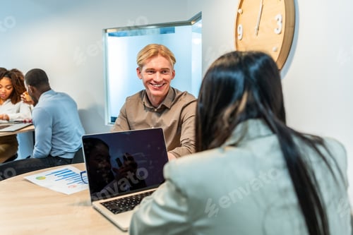 Preview: Managers smiling and talking during a coworking meeting