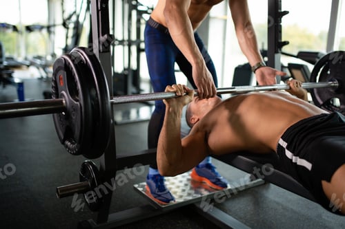 Preview: Young fit man exercising in a gym. Sport people healthy lifestyle concept