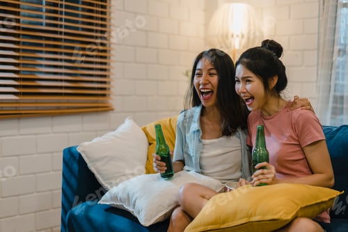 Preview: Asian female drinking beer watching TV cheer soccer funny moment together.