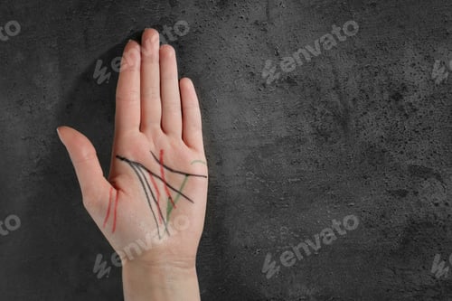 Preview: Top view of woman showing palm with drawn lines at table, space for text. Chiromancy and foretelling