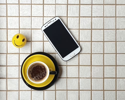 Preview: Minimal style coffee with phone on white tiled tabletop