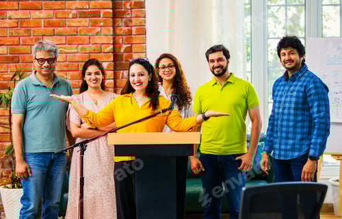 Preview: Indian Confident startup leader delivers speech at business conference while her team claps behind