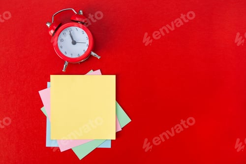 Preview: Alarm clock on red background.