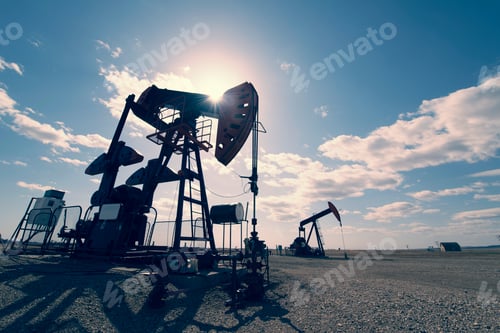 Preview: A pump jack in open ground at an oil extraction site.