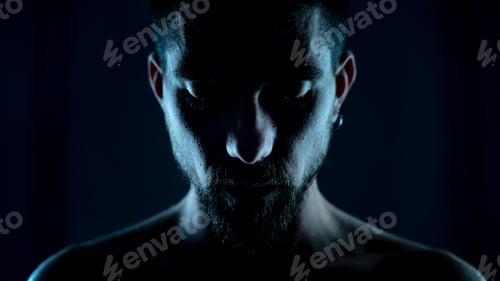 Preview: Portrait of attractive young male model in cinematic backlight on black background without shirt