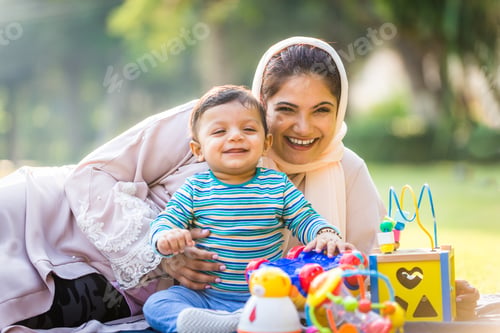 Preview: Arabic mom and her little toddler playing outdoors