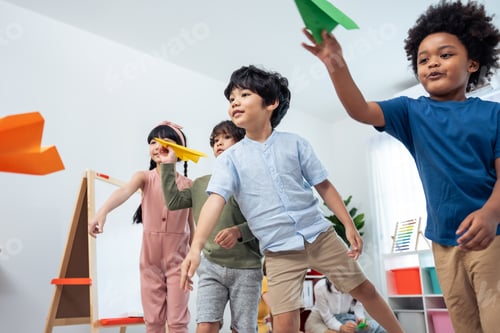 Preview: Enthusiastic Children Launching Paper Airplanes Indoors
