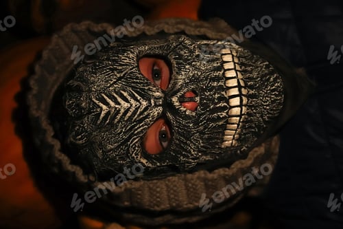 Preview: Defocus Halloween people. Person in grim reaper mask standing on