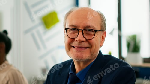 Preview: Close up of senior project manager looking at camera smiling