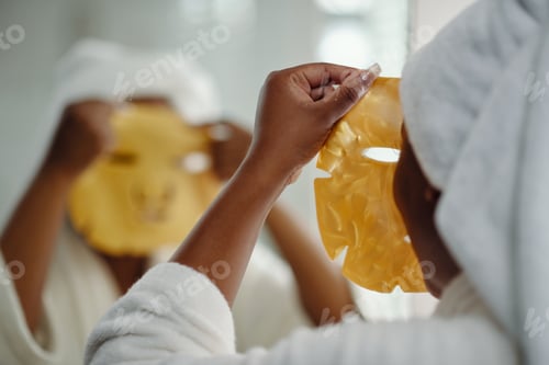 Preview: Applying Skin Care Mask While Wearing White Bathrobe
