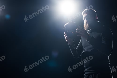 Preview: Young bearded man wearing headphones