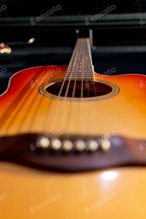 Preview: close-up shot of classical acoustic guitar strings from wood hanging on the wall in a music studio