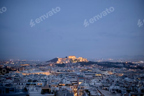 Preview: Aerial view of Athens at dusk with the Acropolis illuminated against the night sky. Greece