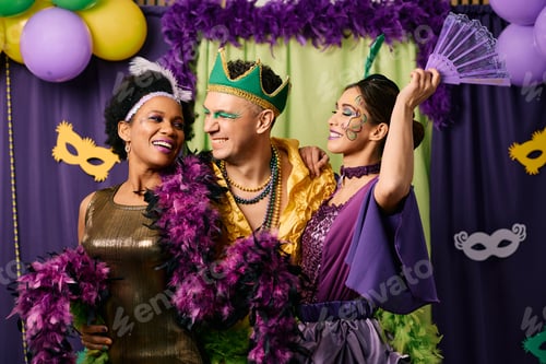 Preview: Happy multiracial people in carnival costumes having fun on Mardi Gras party.