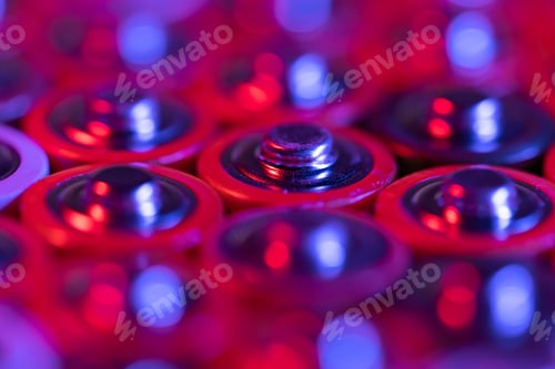 Preview: Closeup of positive ends of discharged batteries AA sizes, macro shot, selective focus. Used battery