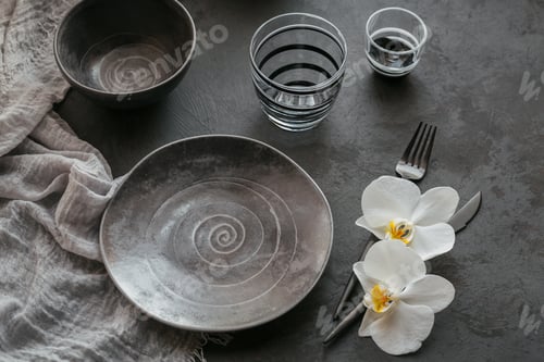 Preview: Elegance table setting with cutlery, ceramic plates, glasses and white orchid flowers