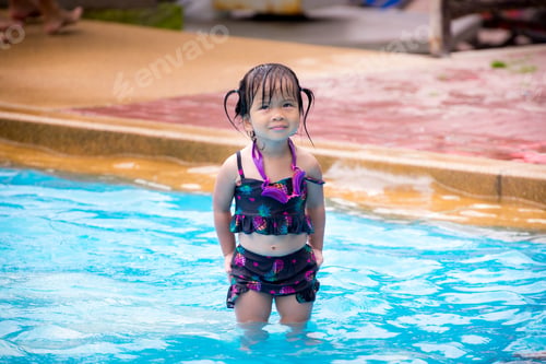 Preview: Child stand in the pool and make funny faces. On a cloudy day. Children left looking at the top.
