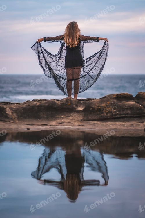 Preview: Lifestyle with a young brunette Caucasian woman in a long black transparent dress