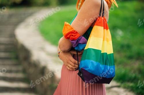 Preview: Woman wearing rainbow bag and scrunchies supporting lgbtq plus rights