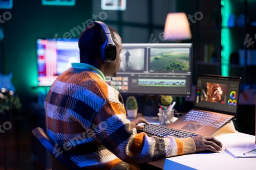 Preview: Videographer expert adjusting movie clips on computer at his home
