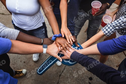 Preview: Sports fans in a huddle at a tailgate event