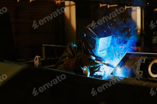 Preview: Factory Worker Welding Metal Parts