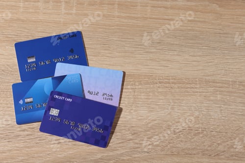 Preview: Online payment. Different credit cards on wooden table, top view. Space for text