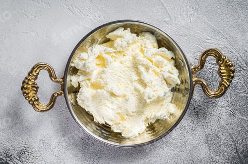 Preview: Turkish Kaymak Clotted cream, butter cream. Gray background. Top view