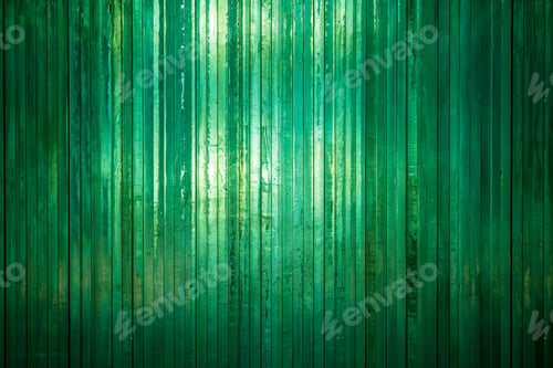 Preview: Wall of brightly coloured green striped thick glass background light shining through warm backdrop.