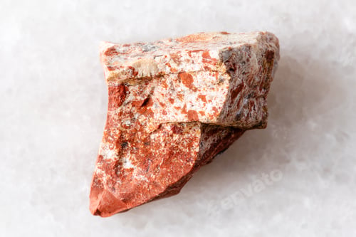 Preview: sample of raw red jasper mineral on white marble