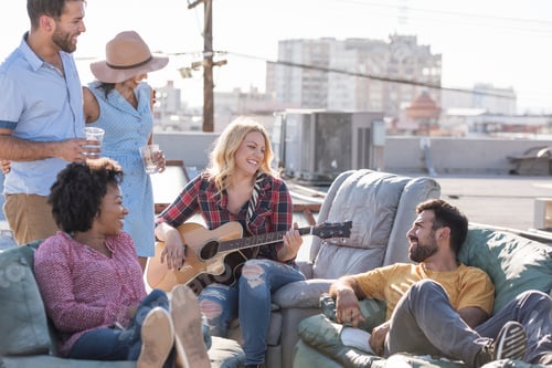 Preview: Friends having a rooftop party and playing guitar