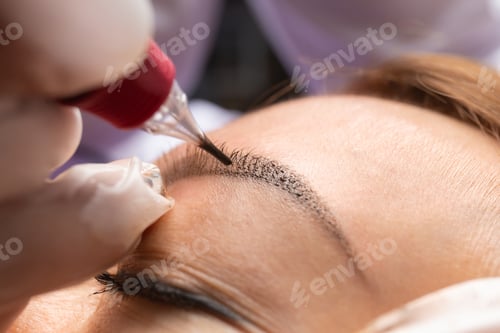 Preview: Beauty master performs permanent eyebrow makeup in a beauty salon, microblading.