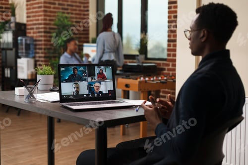 Preview: Marketing agency office worker talking with coworkers on digital video meeting call