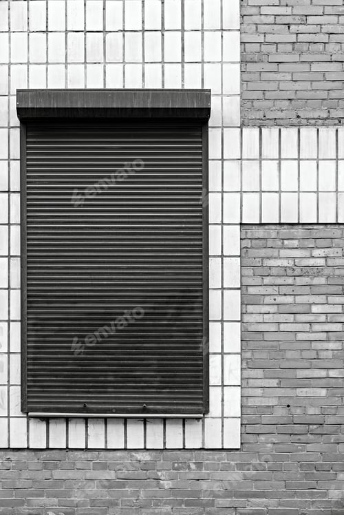 Preview: Monochrome Abstract Facade Of The Building With A Facing Tile And A Bricklaying And Iron Blinds
