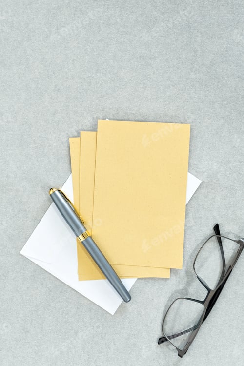 Preview: Greeting card with pen and glasses on gray background.