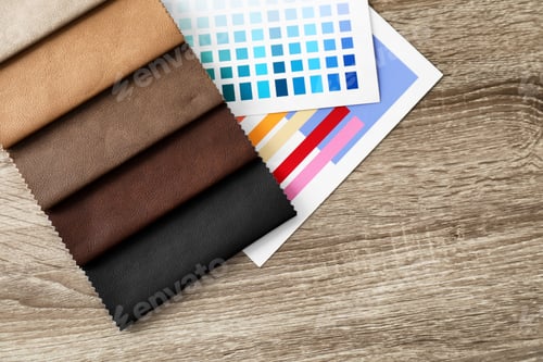 Preview: Upholstery fabric samples and color palette on table. Interior design