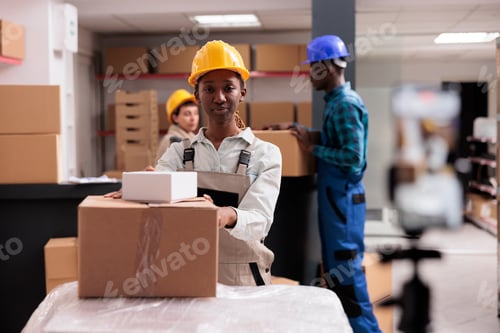 Preview: African american warehouse operator managing parcels receiving portrait