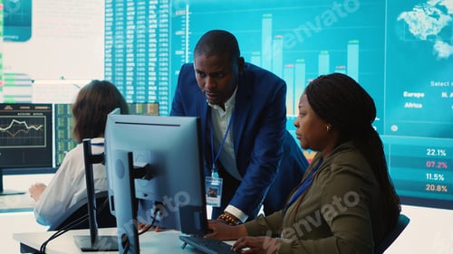 Preview: Financial analyst works on resource allocation plans with his staff