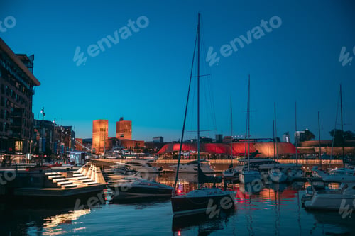 Preview: Oslo, Norway. Night View Embankment, Oslo City Hall And Moored Yachts Near Aker Brygge District