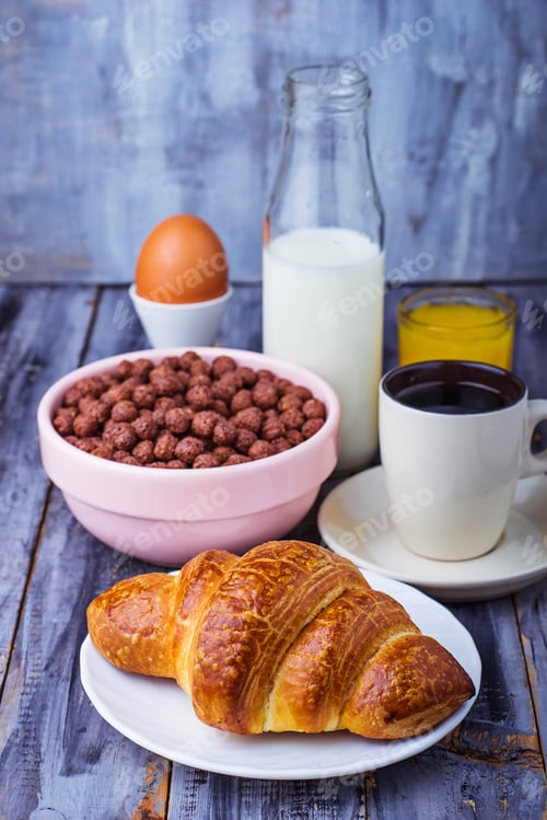 Preview: Croissant, cereal flake, coffee, milk, orange juice, boiled egg for breakfast